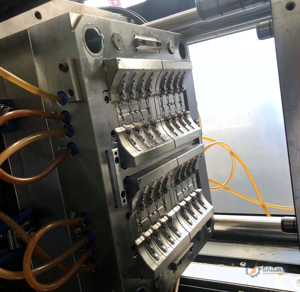 16-cavity edible oil cap mold mounted on injection machine platen with cooling lines Sailwin