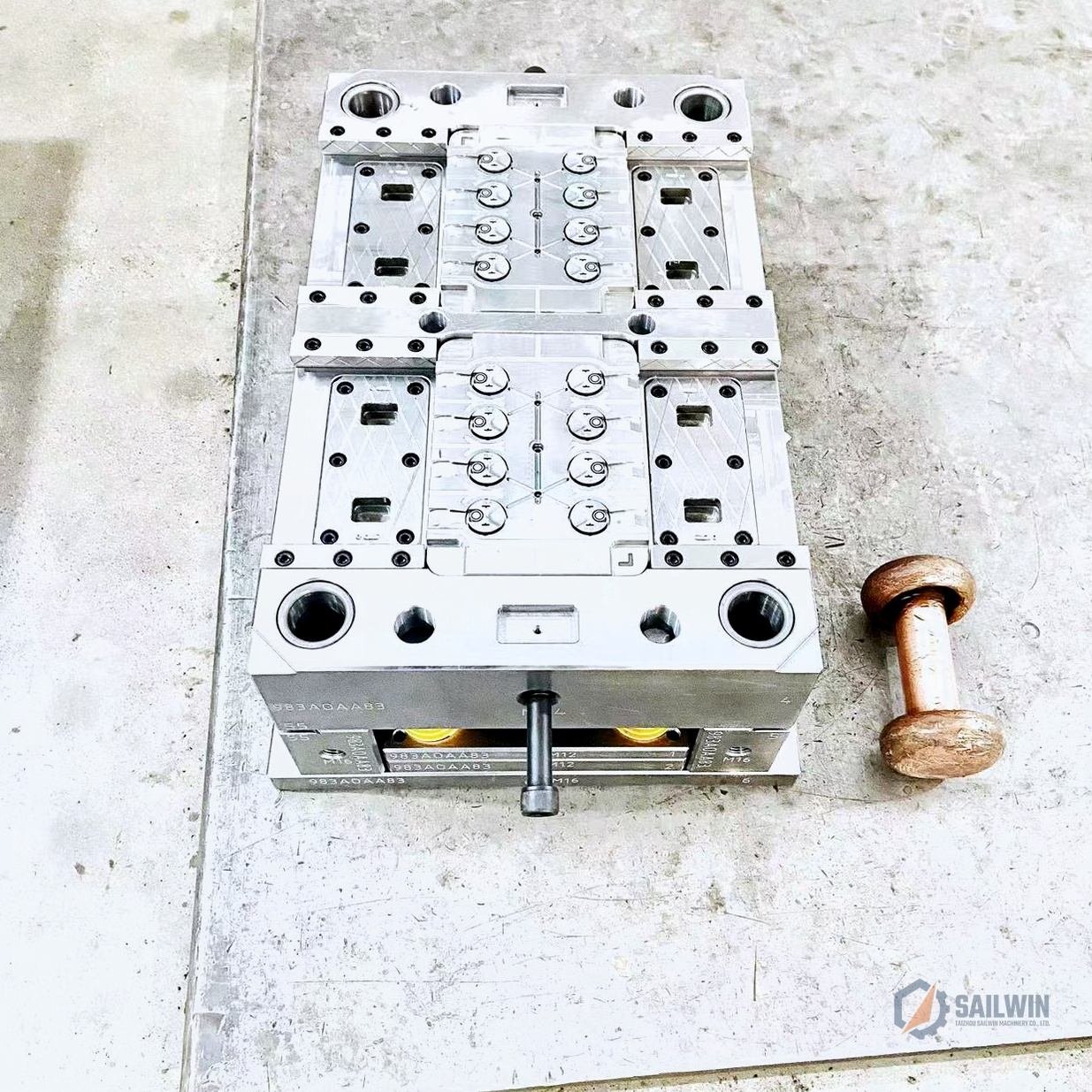 16-cavity edible oil cap injection mold cavity plate with copper mallet on assembly bench Sailwin