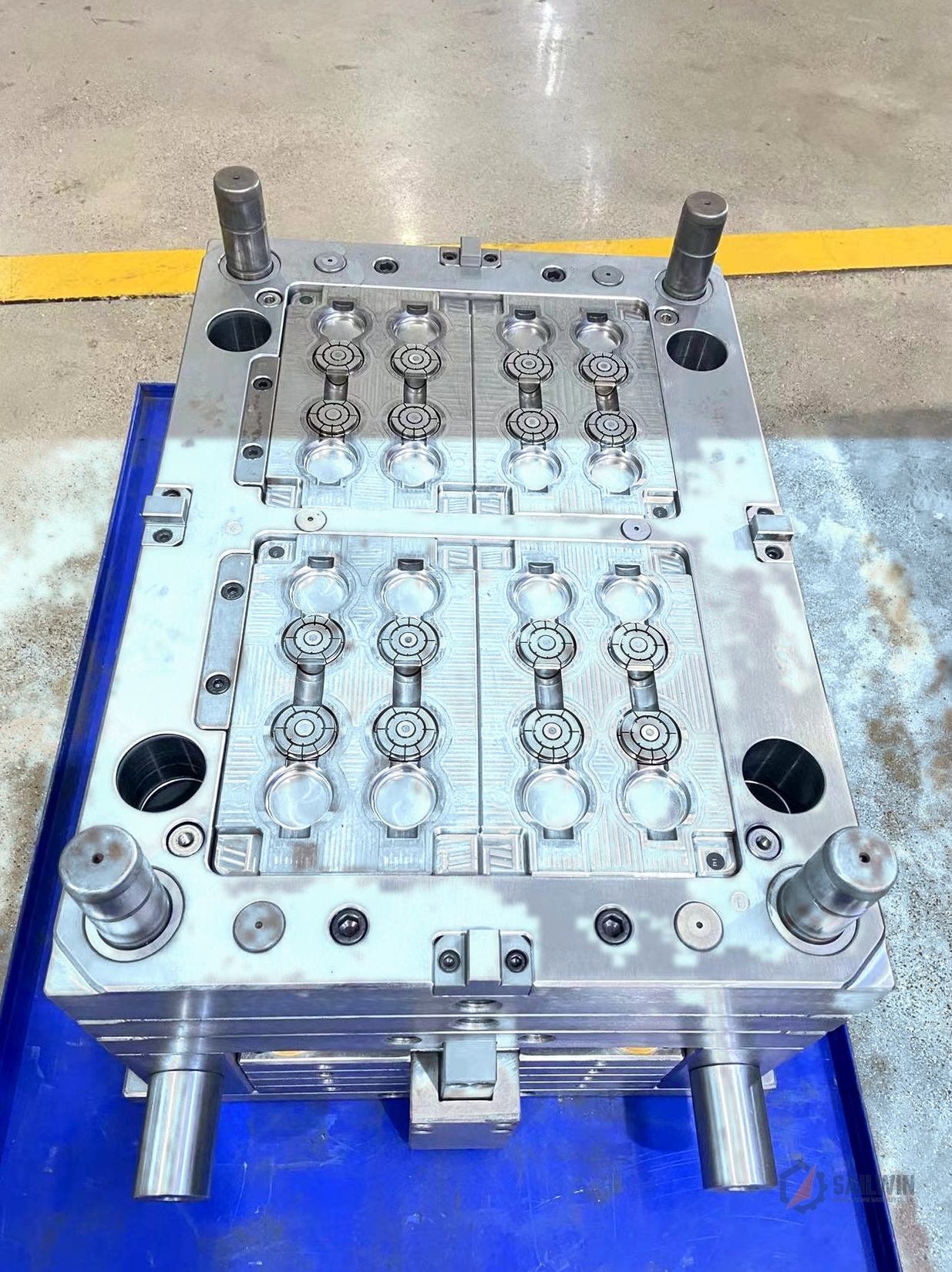 24-cavity oil cap mold with slide stripper mechanism on pallet in workshop with blue floor Sailwin