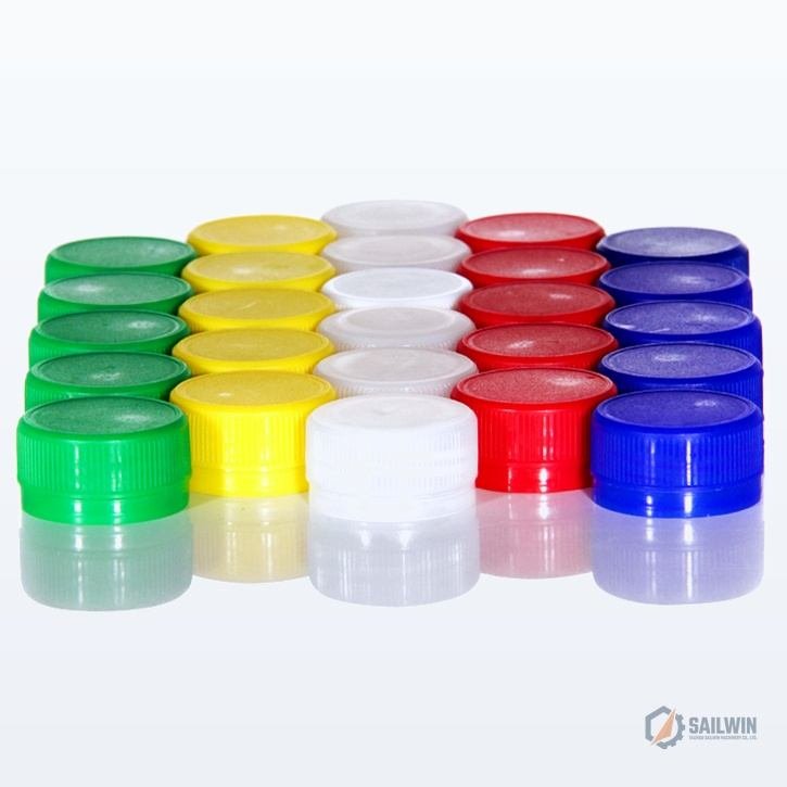 5x5 grid array of colorful beverage bottle caps with mirror reflection on studio floor Sailwin