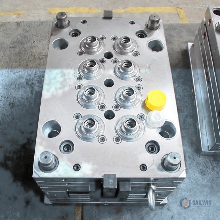8-cavity motor oil cap mold assembly with yellow safety pull-out spout caps on blue floor Sailwin
