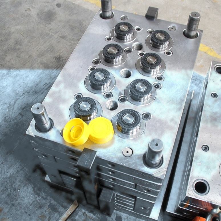 8-cavity pull-out spout cap mold core plate on workshop floor with distressed blue epoxy finish Sailwin