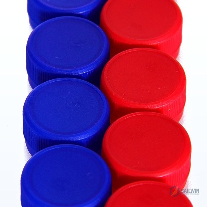 Dual-row blue and red plastic water bottle closures on clean studio background Sailwin