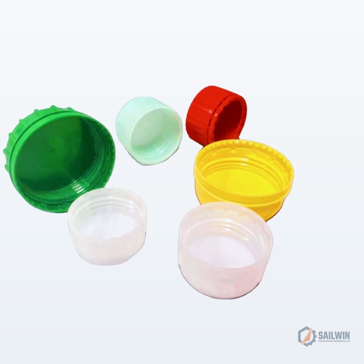 Multi-color ribbed plastic cooking oil bottle closures and screw caps on studio background Sailwin
