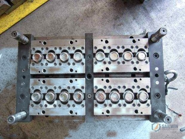 Precision cap injection mold core plate in clean workshop with distressed blue epoxy floor Sailwin