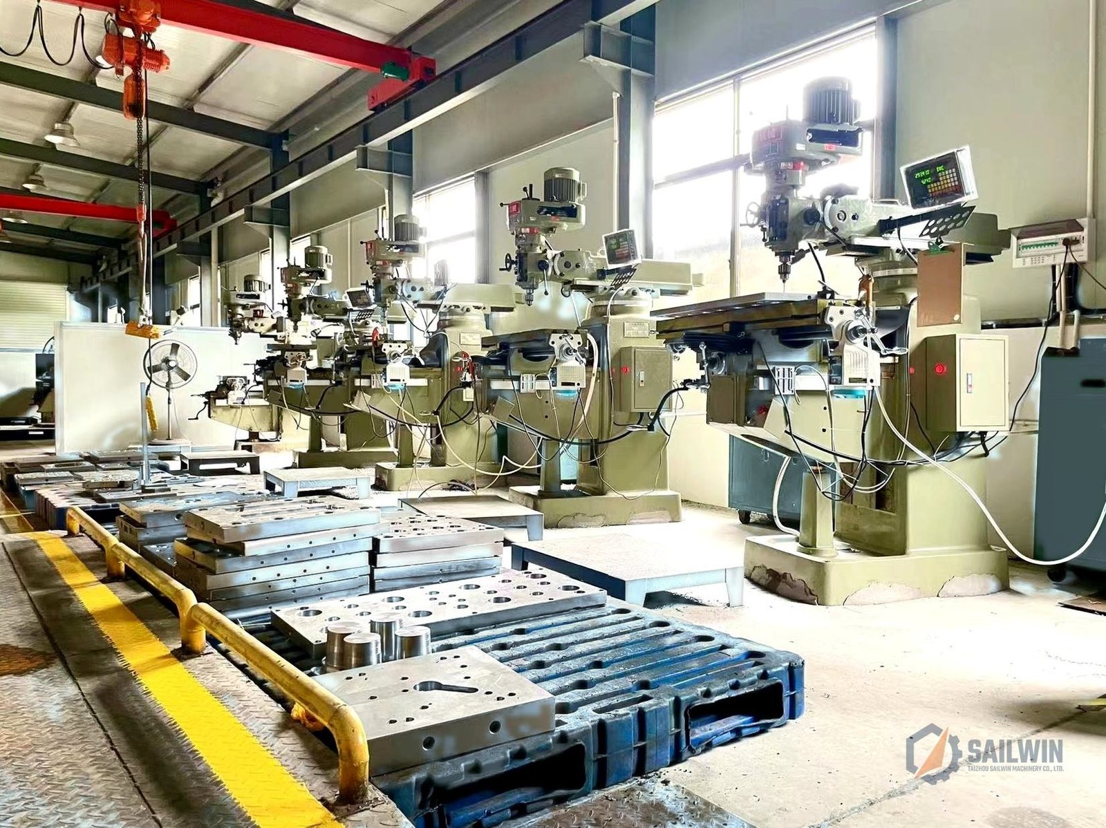 Sailwin precision milling machines workshop with safety guardrail and distressed blue floor Sailwin