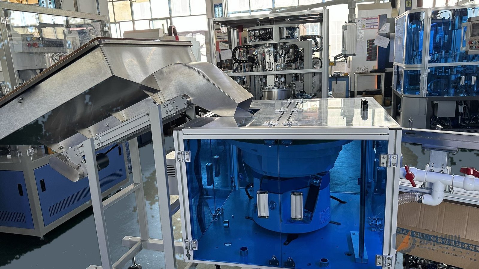 Soundproof acrylic enclosure and storage hopper on wine cap assembly machine Sailwin