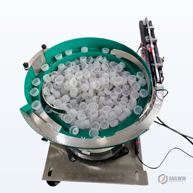 Top view of spiral vibrating cap feeder bowl showing internal orienting track and sorting baffles Sailwin
